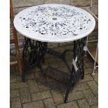 A Singer treadle sewing machine base converted to a garden table with circular reticulated metal