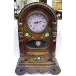 A substantial arched time piece, hand painted with flora,