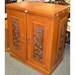 A Burmese teak drinks cabinet butterfly wing top two doors opening to cupboard drawers wine rack