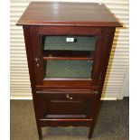 An early 20th century mahogany music cabinet, moulded top, glazed door enclosing shelving,