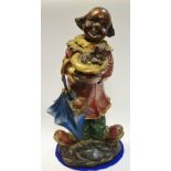 A Bronzed figure of a clown, carrying puppy in hat, another hiding in umbrella, 43cm high.