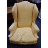 A wingback fireside chair scrolling arms squab cushion acanthus carved cabriole forelegs.