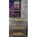 A wrought iron folding four shelf unit. 198cm high.