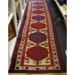 A Hand Made Persian Sarab Runner, red and cobalt hexagonal design on cream ground, 453cm x 100cm.