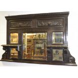 A Gothic revival oak overmantel, an arrangement of five mirrors,