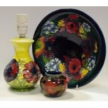 A Moorcroft orchid pattern bowl; a small pomegranate pattern ovoid vase (af);
