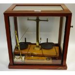 A set of balance scales and weights in a case