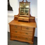 An Edwardian light oak dressing table, rectangular mirror,