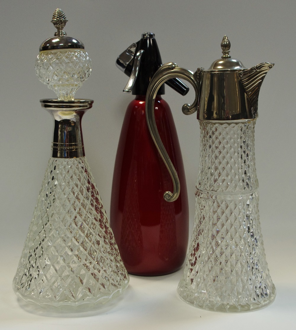 A claret jug with plated mounts; a confirming decanter;