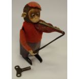 A Schuco clockwork violin playing monkey, with key c.