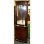 A floor standing bowfront corner cabinet, glazed door to top, projecting base,