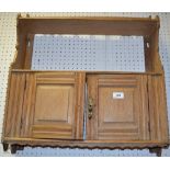 A small oak wall cupboard, spindled galleried shelfmover two fielded panel door cupboard.