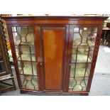 An Edwardian mahogany display cabinet, ogee cornice, fielded panel central door enclosing shelving,