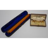 A 9ct gold mounted cheroot holder, fitted case; an 18ct gold stud (1.