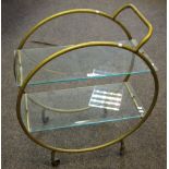 An Art Deco style brass tea trolley with glass shelving.