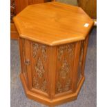 A Burmese teak occasional table/ cabinet octagonal top two doors opening to shelving carved with