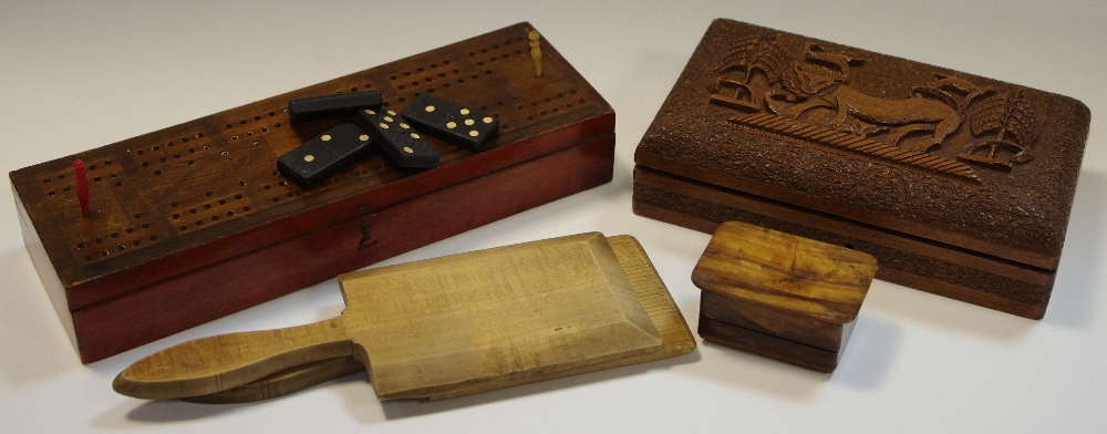 Treen - a cigarette case carved with a lion and other fauna; an early 20th century butter pat;