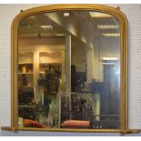 A gilt framed overmantel mirror, arched top.