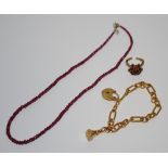 A gold plated Albert bracelet; a ruby necklace;