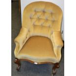 A Victorian mahogany button back arm chair, serpentine stuffed overseat, cabriole legs,