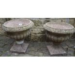 A pair of reconstituted stone pedestal planters