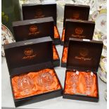 A set of six Webb champagne glasses, boxed; a set of six Webb brandy glasses,