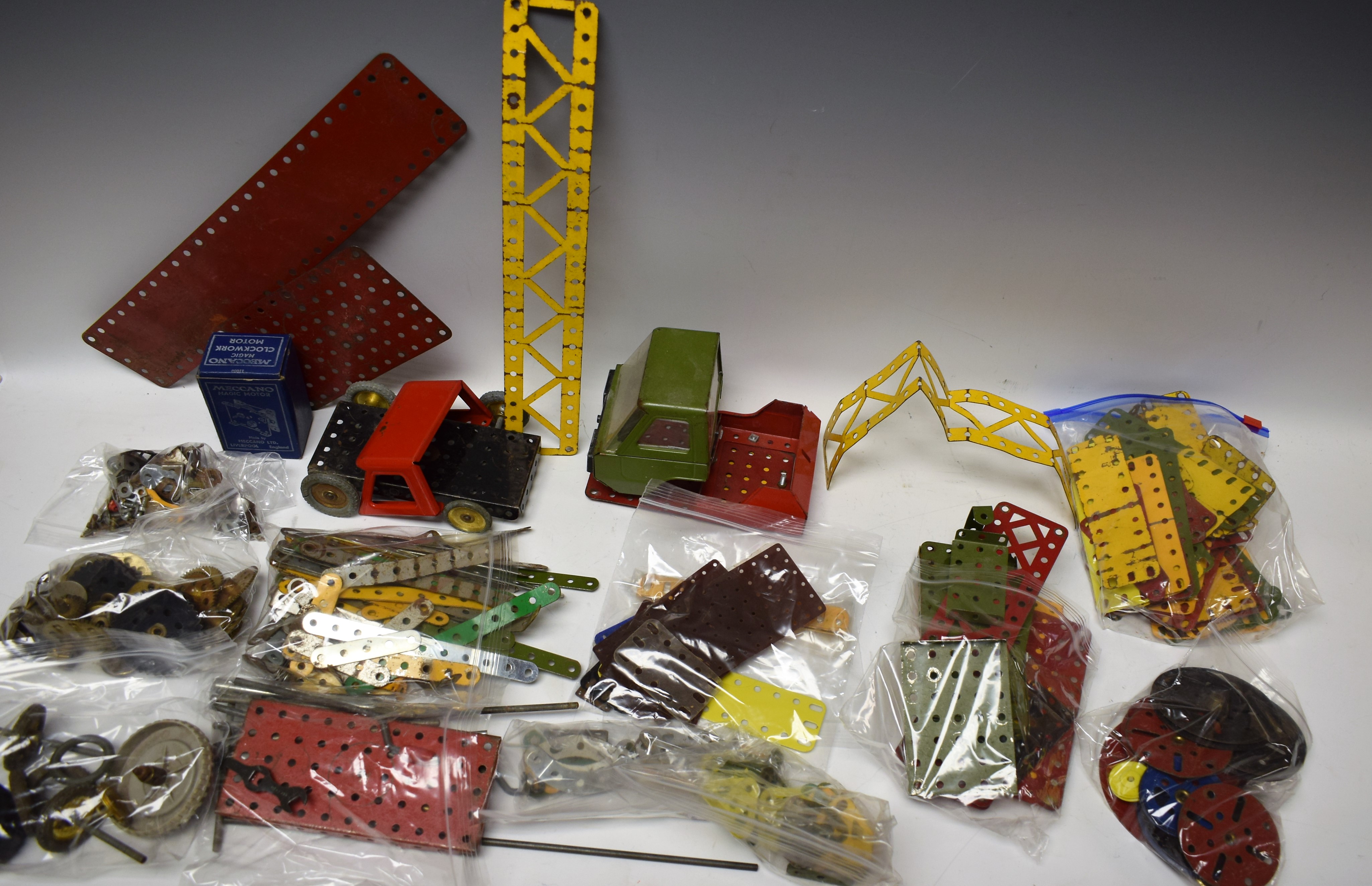 Meccano - an assortment of pieces, Magic Motor with box, wheels,