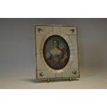 A late 19th century portrait miniature of an elegant young lady