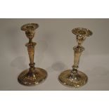 A pair of 20th century silver candlesticks, oval weighted bases,