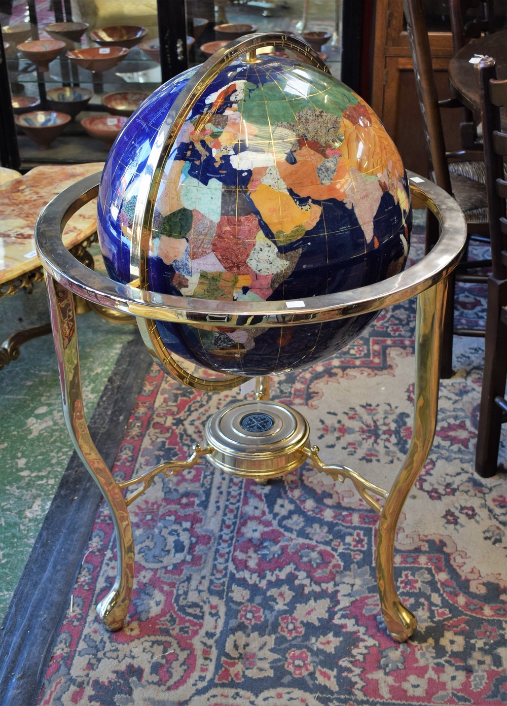 A metal mounted specimen stone set floor standing terrestrial globe,