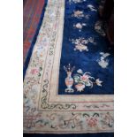 A Chinese style carpet, on a midnight blue ground,