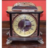 An Odo bracket style mantel clock, brass dial, twin winding holes, Roman and Arabic numerals,