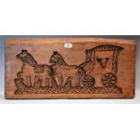 A softwood gingerbread mould, recess carved with a horse-drawn carriage,