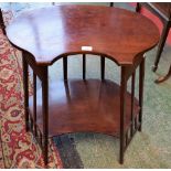 An Art Nouveau mahogany occasional table, shaped oval top above a conforming, but chamfered,