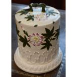 A late 19th century stilton cover on stand, embossed and painted with flowers,