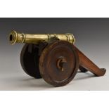A 19th century bronze signal canon, 27cm barrel, hardwood carriage and wheels, 44cm long overall, c.
