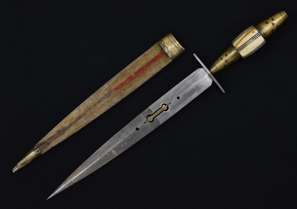 A Middle Eastern dagger, 25cm pointed double-edged blade pierced and chased,