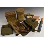 A World War Two field saw, military green canvas wrap; a later field medical kit,