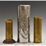A 1917 German shell vase, decorated with a sunflower, and nickel plated,