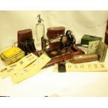 Boxes and Objects - a Jones hand cranked sewing machine; a brass Pyrene fire extinguisher;
