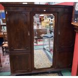 An early 20th century mahogany triple wardrobe,