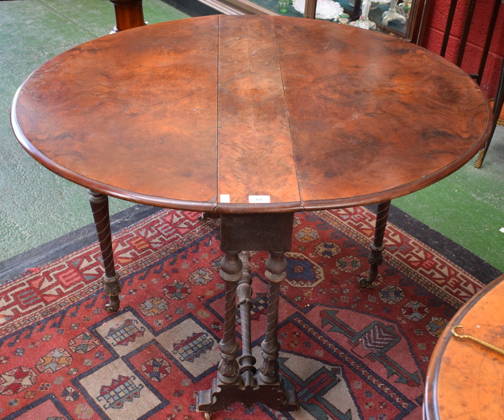 A Victorian walnut Sutherland table, moulded oval top with fall leaves,