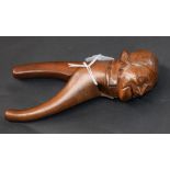 A Black Forest novelty lever-action nut cracker, carved as a gentleman wearing a nightcap,