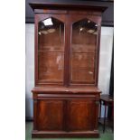A 19th century mahogany bookcase, outswept cornice above a pair of glazed doors,