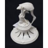 A German porcelain model, of a Stork, pierced stepped circular base, glazed throughout in white, 10.