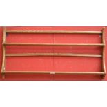 An Ercol style elm wall hanging plate rack, 96.