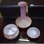 A Moorcroft polychrome pale pink and purple powder bowl and cover; a similar bowl and waisted vase,