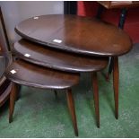 A nest of three Ercol pebble shaped graduated coffee tables,