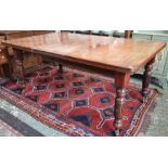 A late Victorian mahogany extending dining table, rounded rectangular top, fluted baluster legs,