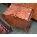 A mid 20th century walnut sewing box, hinged covers enclosing concertina action compartments,